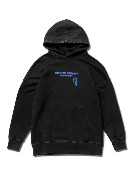 Black Drone Repair Shop Hoodie showcasing the logo with blue text detailing, combining street style with a nod to tech enthusiasts, presented on a white backdrop.