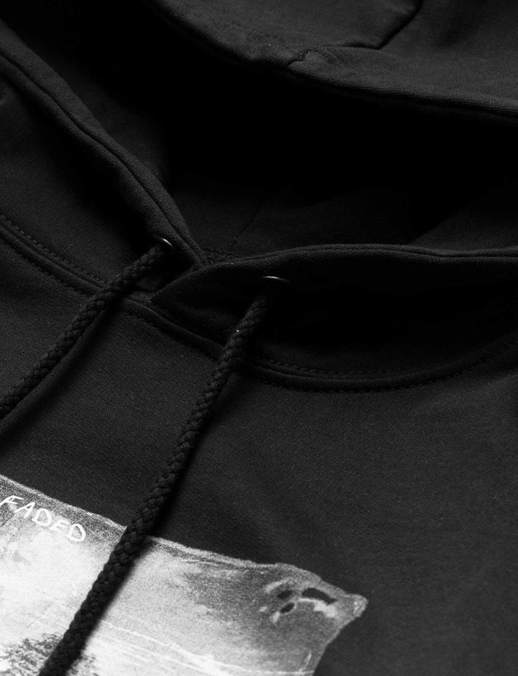 Close-up of the black drawstrings and hood detail on Alan Walker's Faded 2.0 Hoodie, with a partial view of the monochrome graphic.