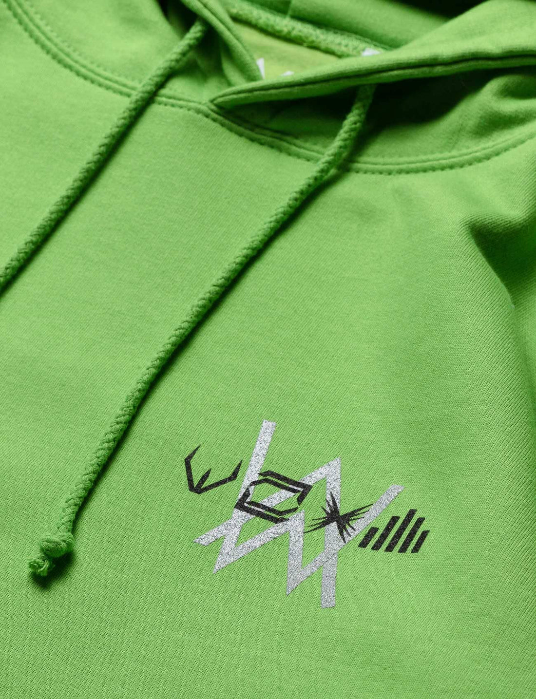 Detailed embroidery of Alan Walker's logo on the green Stage Hoodie, highlighting quality craftsmanship.