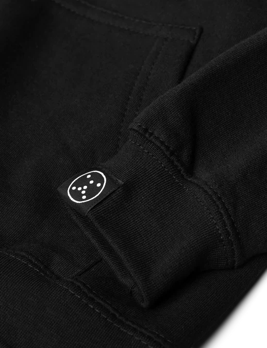 Detail on the sleeve of the kids black hoodie showing the unique Alan Walker patch, a subtle branding touch.