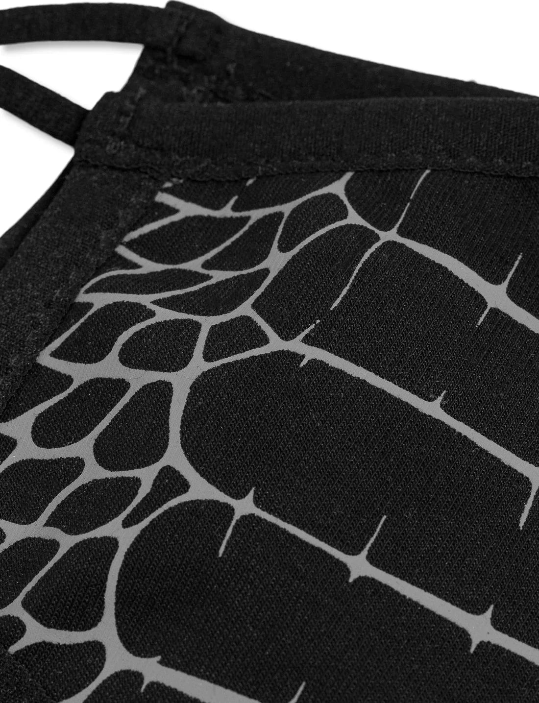 Detail of the reflective spider web design on a black face mask, highlighting the intricate pattern and texture, emphasizing the mask's unique aesthetic feature.