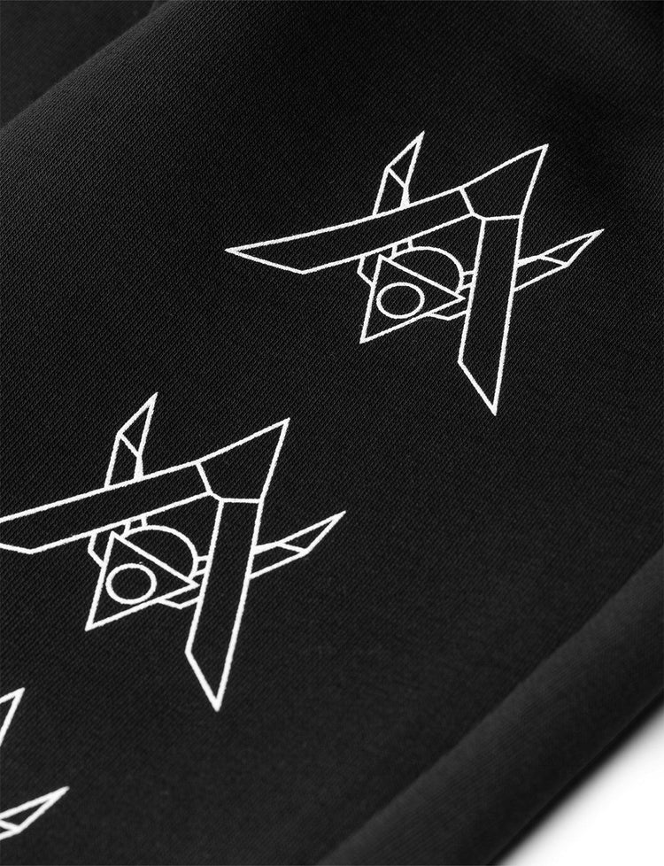 Close-up view on the lower leg of the Alan Walker Core Drone Sweatpants showcasing the series of white drone silhouette graphics, highlighting the detail against the black fabric.
