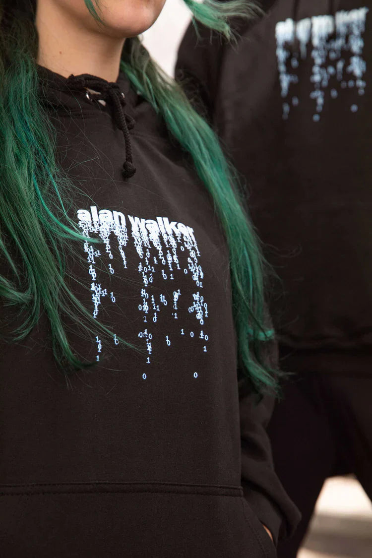 Female model in a black hoodie with 'alan walker' digital rain design, merging tech-inspired fashion with casual wear.