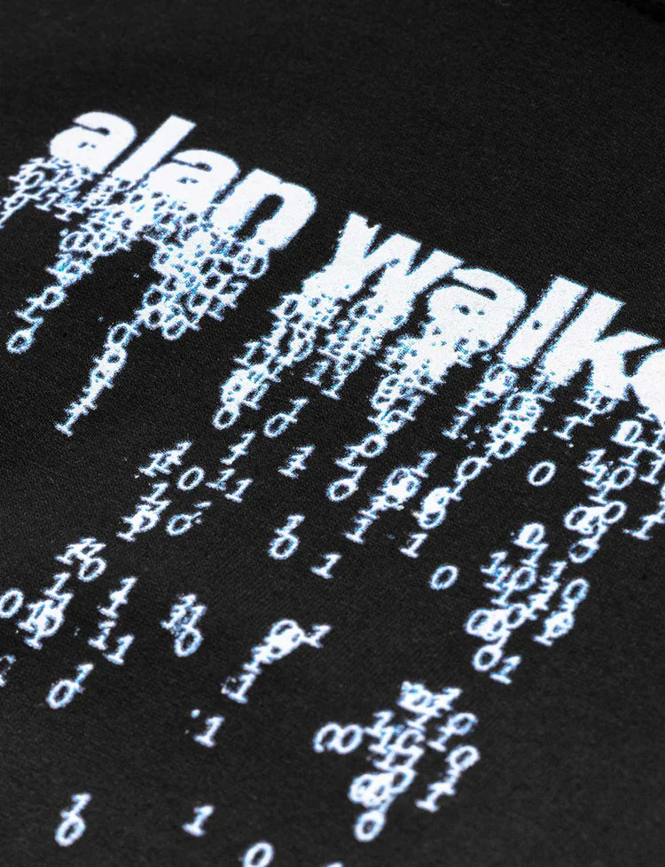 Close-up of a black hoodie's front with 'alan walker' digital rain graphic, a fusion of music and matrix-inspired style.