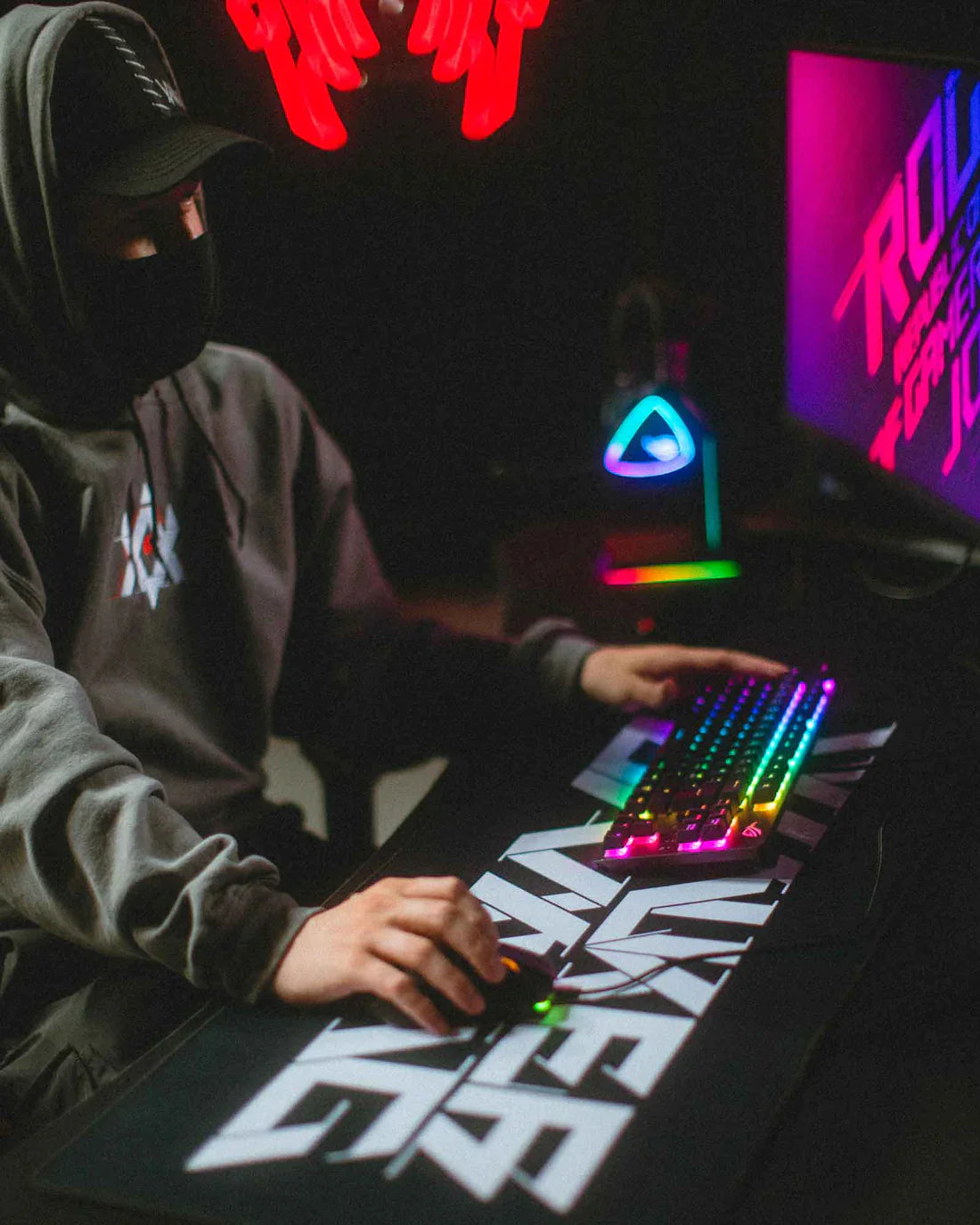 Gamer engaging in an immersive gaming experience with the Alan Walker design mousepad, complete with mood lighting.