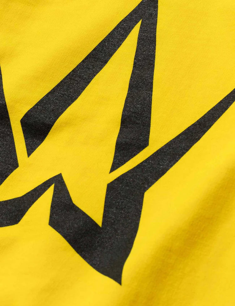 Close-up of the bold Alan Walker symbol on the back of a yellow hoodie for kids.