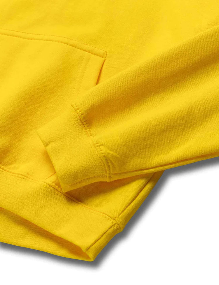 Detailed view of the cozy kangaroo pocket on the Alan Walker yellow children's hoodie.