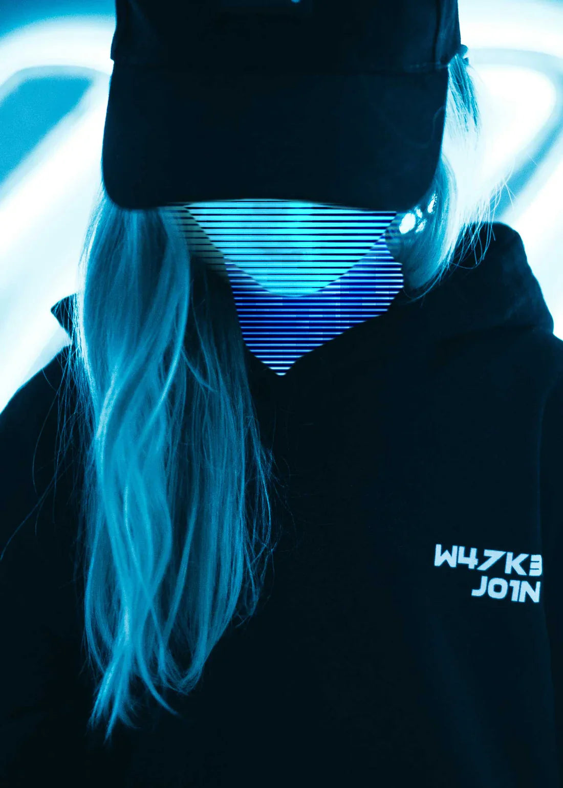 A child in a black Alan Walker hoodie and LED mask, embracing the electro music culture in style.