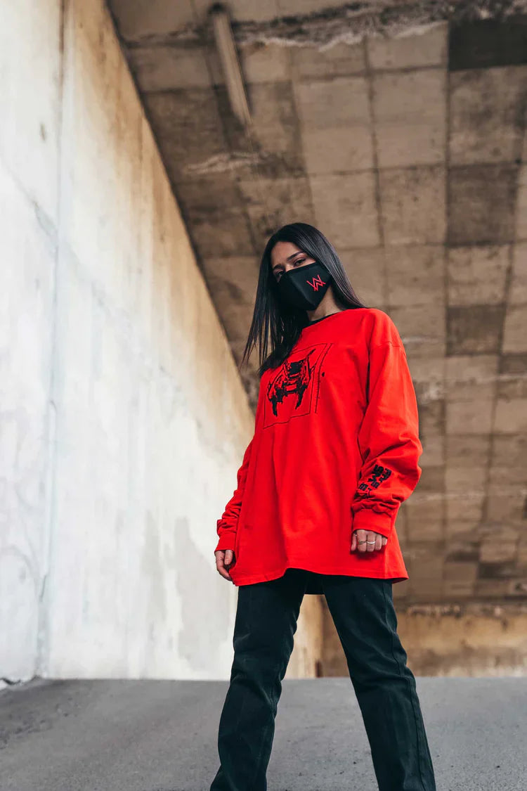 Stylish urban outfit complemented by a black face mask with the Alan Walker red logo, exuding a modern vibe.