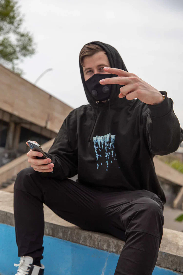 Casual pose of Alan Walker wearing an 'alan walker' digital rain graphic hoodie, exuding a relaxed yet edgy vibe.