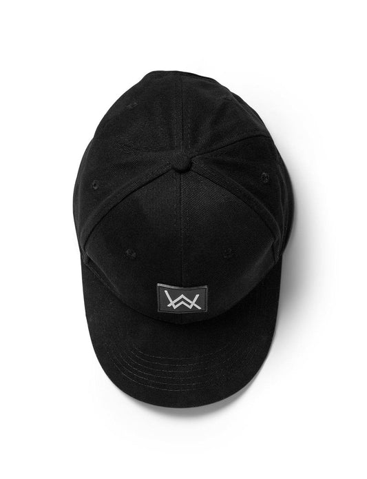 Alan Walker Core Logo Cap in black, featuring a centered white 'AW' logo patch on the front panel, with a structured six-panel design and adjustable strap, displayed against a white background.