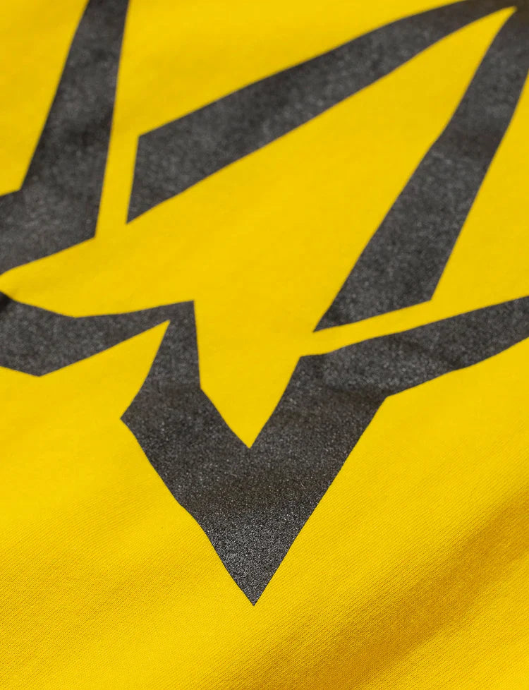 Zoomed-in view of the bold Alan Walker symbol on the Yellow Walkerverse 2.0 Hoodie.