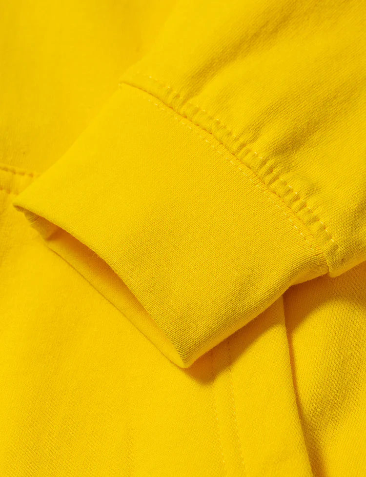 Close-up of the high-quality sleeve stitching on the Yellow Walkerverse 2.0 Hoodie.