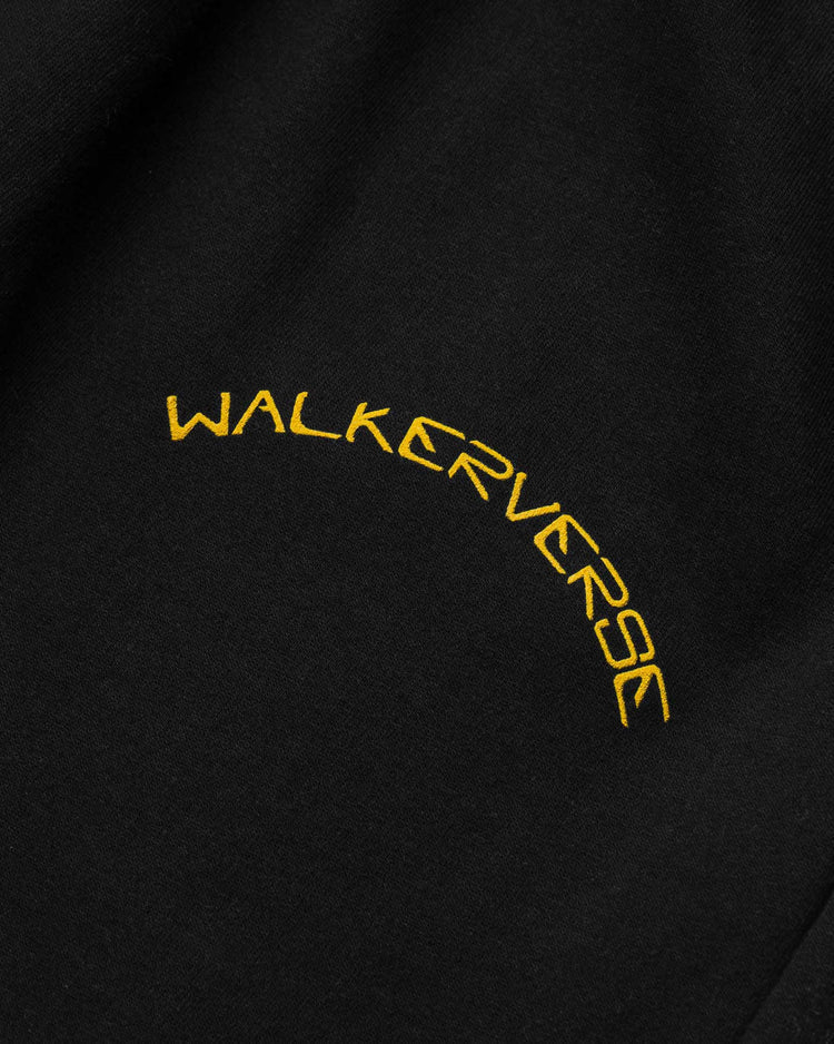 Close-up of the Walkerverse arc logo on black sweatpants.