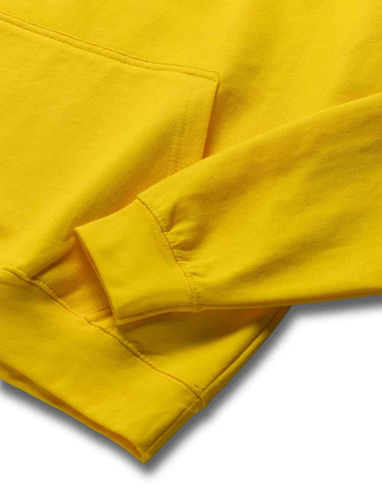 Close-up of the soft, yellow fabric and cuffs of Walkerverse Stage Hoodie.