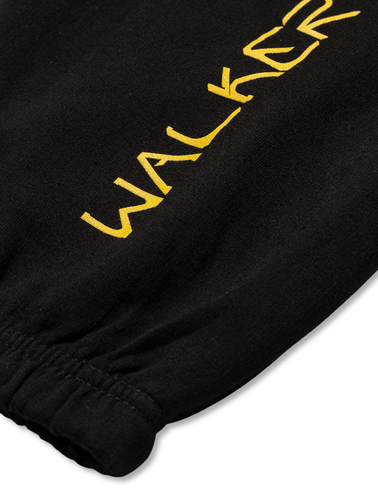 Black Walkerverse 2.0 Sweatpants leg detail highlighting the elongated yellow Walkerverse print down the side.